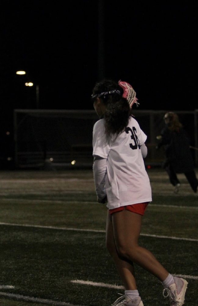 Freya Larson under the lights at night in her Mount Si uniform, number 36